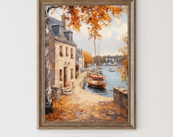 May include: Framed art print of a European coastal scene. The painting depicts a stone building with a blue roof, boats docked in the water, and autumn foliage. The artwork is in a wooden frame. The text "ISLE & PINE ART COLLECTION" is at the bottom.