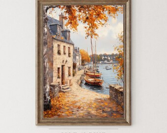May include: Framed art print of a European coastal scene. The painting depicts a stone building with a blue roof, boats docked in the water, and autumn foliage. The artwork is in a wooden frame. The text "ISLE & PINE ART COLLECTION" is at the bottom.