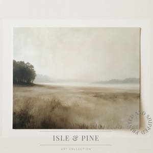 May include: A landscape art print depicting a misty field with tall grasses and a line of trees. The colour palette is muted, with browns and beiges dominating the scene. The text "ISLE & PINE" and "ART COLLECTION" are visible at the bottom.