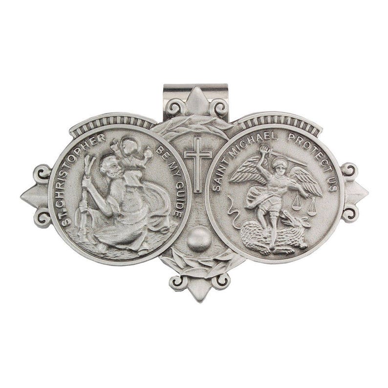 May include: Silver tone metal pendant with three round medallions. The medallions feature images of Saint Christopher, Saint Michael, and a cross. The text "Saint Michael Protect Us" and "Be My Guide" are inscribed on the medallions.
