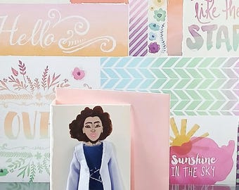 May include: A greeting card featuring a hand-drawn illustration of a person with dark curly hair, wearing a light purple open jacket over a dark blue top, a patterned skirt, black leggings, and light-colored shoes, set against a light pink background.