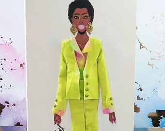 May include: A greeting card featuring a fashion illustration of a person with short dark hair, wearing large gold textured earrings and a bright lime green suit over a multicolored pastel shirt. The person is blowing a bubble and holding a gold script.