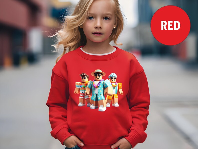 Puede incluir: Una sudadera roja con cuello blanco, que muestra un gr&aacute;fico de tres personajes de dibujos animados con atuendos de vacaciones. La palabra "RED" est&aacute; en un c&iacute;rculo rojo en la parte superior derecha.