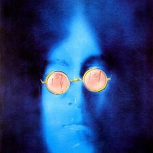 May include: A blue-toned portrait of John Lennon, with his face and round glasses with pink lenses. The name "John Lennon" is printed in white at the top. The image has a vintage, artistic style, reminiscent of a poster.