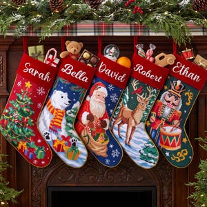 May include: Five Christmas stockings hanging in a row, each featuring a red velvet cuff with a white embroidered name: Sarah, Bella, David, Robert, and Ethan. The stockings display festive scenes including a tree, polar bear, Santa, deer, and nutcracker.