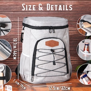 May include: A gray insulated backpack cooler with black accents and a brown leather patch. The cooler measures 18.1 inches (46 cm) high, 12.5 inches (32 cm) wide, and 7.4 inches (19 cm) deep. It features a top zipper, side mesh pockets, and a front bungee cord design.
