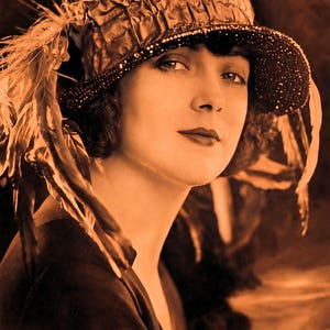 May include: A sepia-toned vintage photograph of a person wearing a textured, ruched cloche hat adorned with long, wispy feathers and a beaded brim. The text at the bottom reads: HATS & HOW TO MAKE THEM DESIGNING PATTERNS & CONSTRUCTING HATS USING 1920S MILLINERY TECHNIQUES.