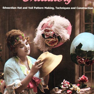 May include: A book cover titled Practical Home Millinery: Edwardian Hat and Veil Pattern Making, Techniques and Construction. It features a person holding a straw hat, with a pink feathered hat and a blue hat nearby on a table.