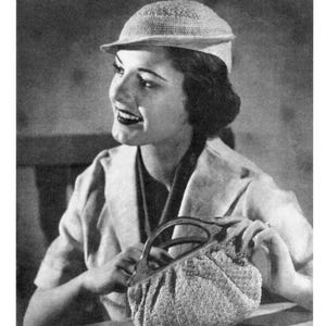 May include: A black and white vintage pattern booklet titled HATS AND BAGS BOOK 74. The cover features a person wearing a textured, brimmed cap and holding a small, soft-textured handbag with a rigid, arched handle. The text 10 CENTS is visible.