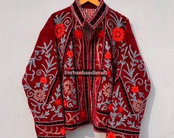 May include: A burgundy velvet jacket with intricate floral embroidery in shades of red, gray, and black. The jacket features a collared neckline and is hanging on a wooden hanger. The text "Farhanhandicraft" is visible on the jacket.