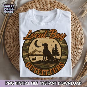 May include: White t-shirt with a circular graphic featuring a black dog silhouette, a crescent moon, and the text "Local Boy Outfitters." The graphic has a camouflage pattern and a mountain and lake scene. The shirt also has the text "PNG DIGITAL FILE INSTANT DOWNLOAD."