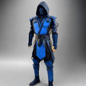 May include: A blue and black cosplay costume with a hood and mask. The costume features a quilted blue chest piece, shoulder pads, and arm guards. A black belt and trousers complete the outfit. The costume is designed to resemble a video game character.