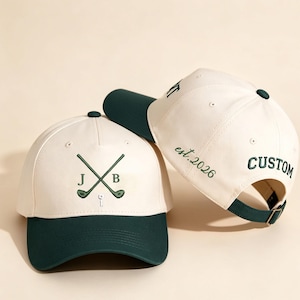 May include: Two white baseball caps with dark green brims. One cap has crossed golf clubs with the initials "J B" and a golf tee embroidered in green. The other cap has the word "CUSTOM" and "est.2026" embroidered in green.