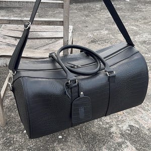 Durable Duffle Bags in Crocodile leather finish for stylish travel.