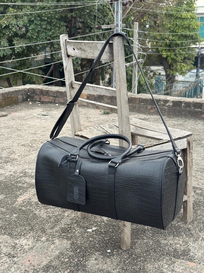Crocodile Embossed Leather Duffel Bag in a luxury studio setting.