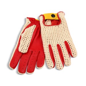 May include: A pair of driving gloves with a cream-colored crocheted back and red leather palms. The gloves have a yellow snap closure and are designed with finger holes for grip and ventilation. The gloves are shown on a white background.