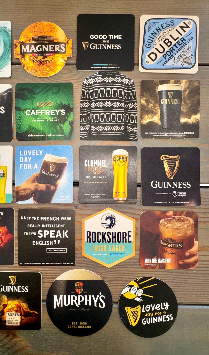 Op de afbeelding: Een verzameling bierviltjes met verschillende merken, waaronder Guinness, Magners en Murphy's. De bierviltjes tonen logo's, tekst en afbeeldingen die verband houden met Iers bier en cider. Sommige hebben citaten.
