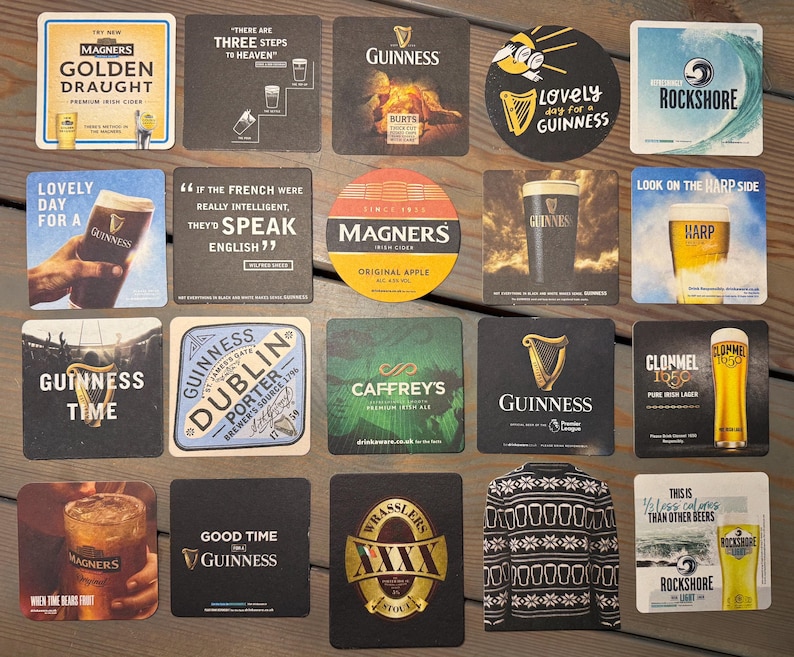 Op de afbeelding: Een verzameling bierviltjes met verschillende merken en ontwerpen. Bierviltjes zijn onder andere van Guinness, Magners, en Rockshore. Sommige viltjes hebben tekst zoals "Lovely Day for a Guinness" en "Good Time Guinness".