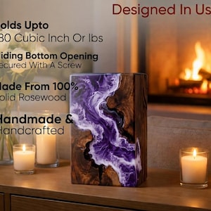 May include: A handmade, solid rosewood urn with a sliding bottom opening, secured with a screw. The urn features a unique design with a purple and white resin river flowing through the wood. Holds up to 180 cubic inches or lbs. Designed in the USA.
