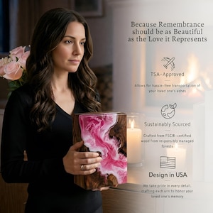 May include: A wooden urn with a pink and white resin design. The urn is held by a person. The text on the image says "Because Remembrance should be as Beautiful as the Love it Represents". The image also includes text about TSA approval, sustainably sourced materials, and design in the USA.
