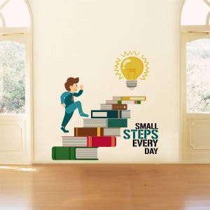 May include: A motivational wall decal showing a cartoon figure ascending a staircase formed of books, leading to a lightbulb. The text "SMALL STEPS EVERY DAY" is displayed. The design uses green, brown, red, and blue hues.