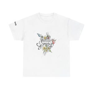 May include: White t-shirt featuring a floral design and the words "hello Spring" in script. The design includes yellow and white flowers, a blue butterfly, and green leaves. The shirt has short sleeves.