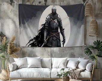 May include: A tapestry featuring a medieval knight in full armor, standing before a large, white, circular backdrop. The knight is depicted in shades of black and gray, with a flowing cape and a sword. The artwork is mounted on a concrete wall.