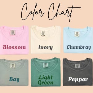 May include: A color chart displays six folded t-shirts in various colors: Blossom, Ivory, Chambray, Bay, Light Green, and Pepper. The text "Color Chart" is written in cursive at the top of the image. Each shirt has its color name printed below it.