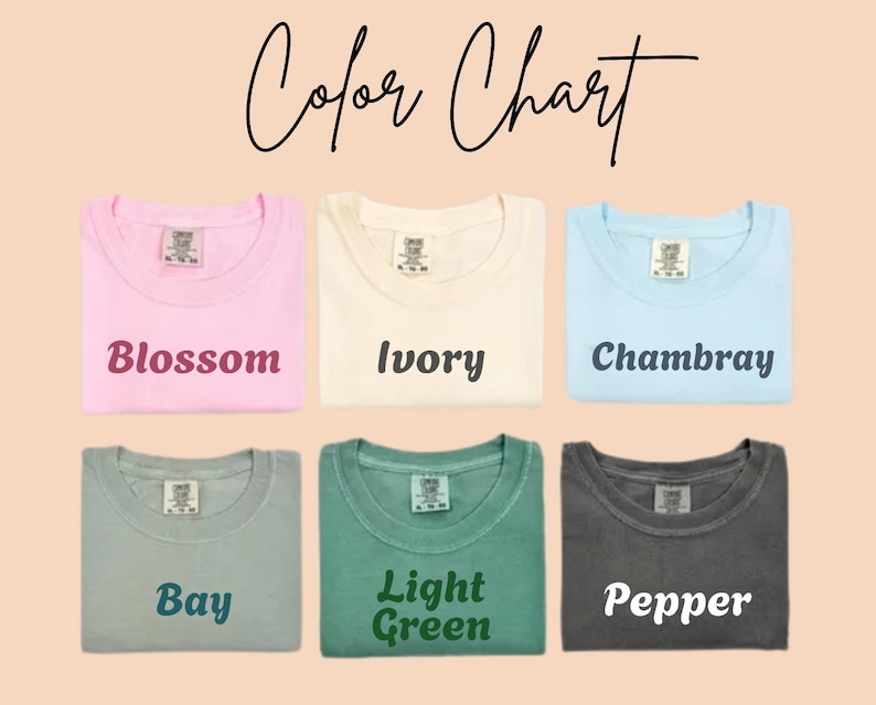 May include: A color chart displays six folded t-shirts in various colors: Blossom, Ivory, Chambray, Bay, Light Green, and Pepper. The text "Color Chart" is written in cursive at the top of the image. Each shirt has its color name printed below it.