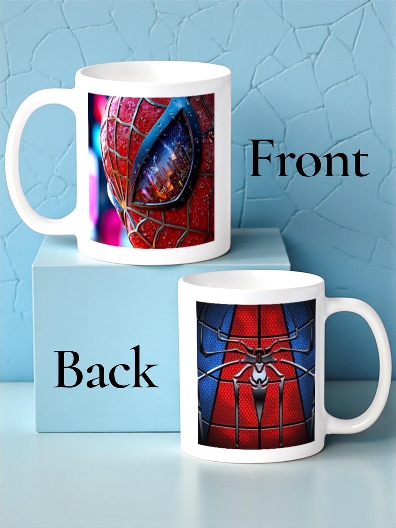 May include: White ceramic mug featuring a close-up of Spider-Man's mask on the front, with red and black detailing. The back of the mug displays the Spider-Man suit design in red, blue, and black. The word "Front" and "Back" are printed on the image.