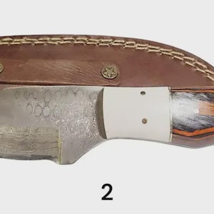 2. Handcrafted skinning knife, Damascus steel blade, exotic wood and camel bone handle with decorative pins and worked leather sheath