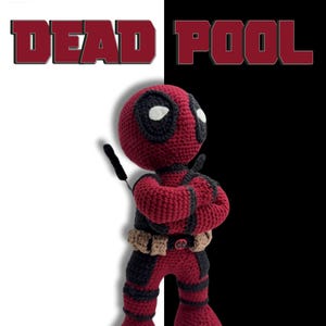 May include: A handcrafted crochet Deadpool figure, featuring a red and black costume, white eyes, and a black mask. The figure is posed with arms crossed. The words "DEAD POOL" are displayed in a bold, red font.