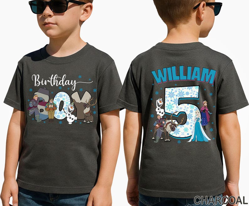 May include: Charcoal gray t-shirt with the text "Birthday Boy" and cartoon characters from a popular animated movie. The back of the shirt features the name "William" and the number "5" with snowflakes and more characters.