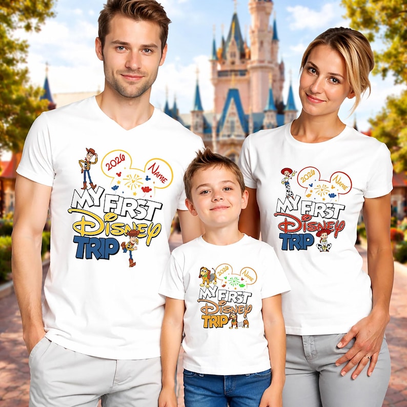 May include: Three people wearing white t-shirts with the text "My First Disney Trip" in a colorful design. The shirts feature Disney characters and the year 2020. The family is posing in front of a castle.