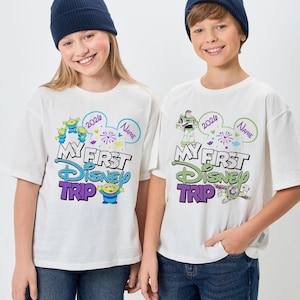 May include: A white ceramic mug with a black handle and the text "But First, Coffee" in a handwritten style. The mug is on a white surface. The mug is approximately 4 inches tall.