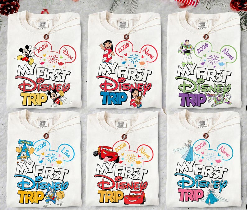 May include: Six white t-shirts with Disney character graphics. Each shirt features "My First Disney Trip" text, a Mickey Mouse ear design, and a character like Mickey, Stitch, Buzz Lightyear, Donald Duck, Lightning McQueen, or Elsa.