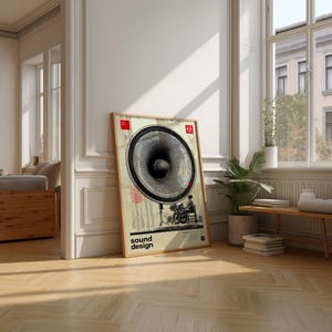 Può includere: Un poster incorniciato con un'illustrazione in stile vintage di un grande altoparlante. Il poster presenta un design di altoparlante in bianco e nero con una persona che aziona l'apparecchiatura. Le parole "sound design" sono stampate in basso.