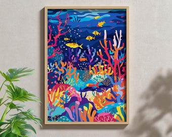 May include: A framed art print depicting an underwater scene. The artwork features colorful coral reefs in shades of red, orange, yellow, and purple, with yellow fish swimming in the blue water. The frame is a light wood color.