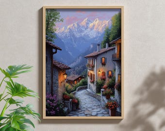 May include: A framed print of a European village scene. The artwork depicts a cobblestone street winding between stone buildings with red tile roofs. Mountains are in the background, and flowers and trees add color. The sky has pink and blue hues.