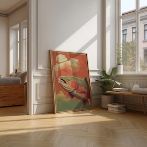 May include: A framed art print featuring a colorful illustration of a trout with a cigarette in its mouth. The artwork has a vintage style with a red and green color palette. The print is leaning against a white wall in a room with hardwood floors.