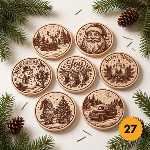 May include: A set of seven round wooden coasters featuring brown engraved holiday illustrations including a reindeer, Santa Claus, a snowman with the text Merry Christmas, stockings with the word Joy, candles with Silent Night, a gnome, and a truck.