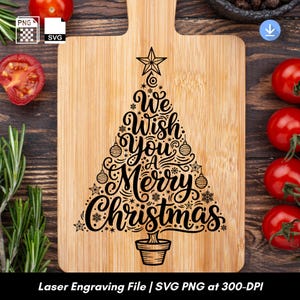 May include: A bamboo cutting board with a Christmas tree design. The tree is made of black script that reads "We Wish You a Merry Christmas." The board is surrounded by tomatoes and rosemary.