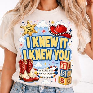 May include: A cream-colored t-shirt featuring a graphic print with a yellow sheriff badge labeled INFINITY AND BEYOND, a red cowboy hat, red and white cowboy boots, a beaded necklace with the text you've got a friend in me, and alphabet blocks.