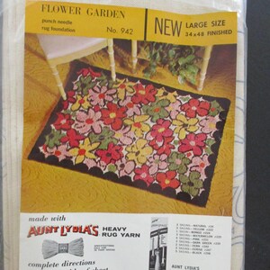 May include: A new, large-size punch needle rug foundation kit. The kit features a floral design with red, pink, yellow, and green flowers on a black background. The finished rug size is 34 x 48 inches. The kit includes Aunt Lydia's heavy rug yarn.