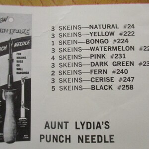 May include: An advertisement for Aunt Lydia's Punch Needle, featuring a punch needle tool and a list of yarn skeins in various colors. The text indicates the product is for making rugs or wall hangings.