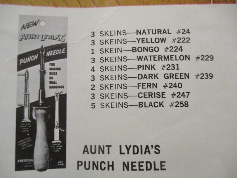 May include: An advertisement for Aunt Lydia's Punch Needle, featuring a punch needle tool and a list of yarn skeins in various colors. The text indicates the product is for making rugs or wall hangings.