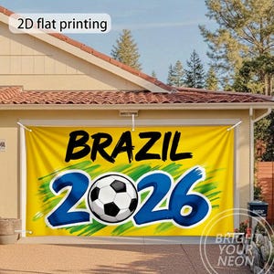 May include: A yellow banner with the word "BRAZIL" in black, and the numbers "2026" in blue, with a soccer ball in the center. The banner is hanging on a garage door.