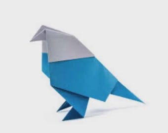 May include: A blue and gray origami bird, crafted from folded paper. The bird is depicted in a side profile, with its wings and tail pointed. The origami bird is set against a plain white background.