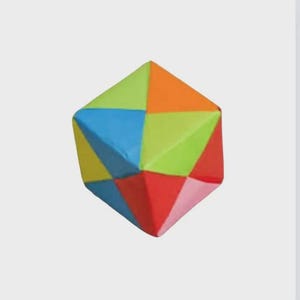May include: A colorful geometric puzzle toy with triangular faces in shades of blue, green, orange, yellow, red, and pink. The toy has a three-dimensional shape and is set against a plain background.