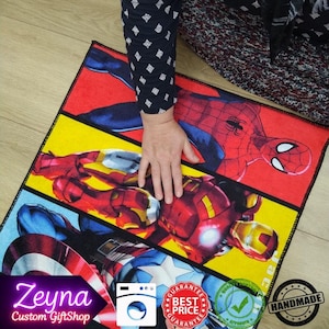 May include: Rectangular Marvel-themed rug featuring Spider-Man, Iron Man, and Captain America in vibrant colors. The rug has a black border and a yellow background. The text "Zeyna Custom GiftShop" is visible.